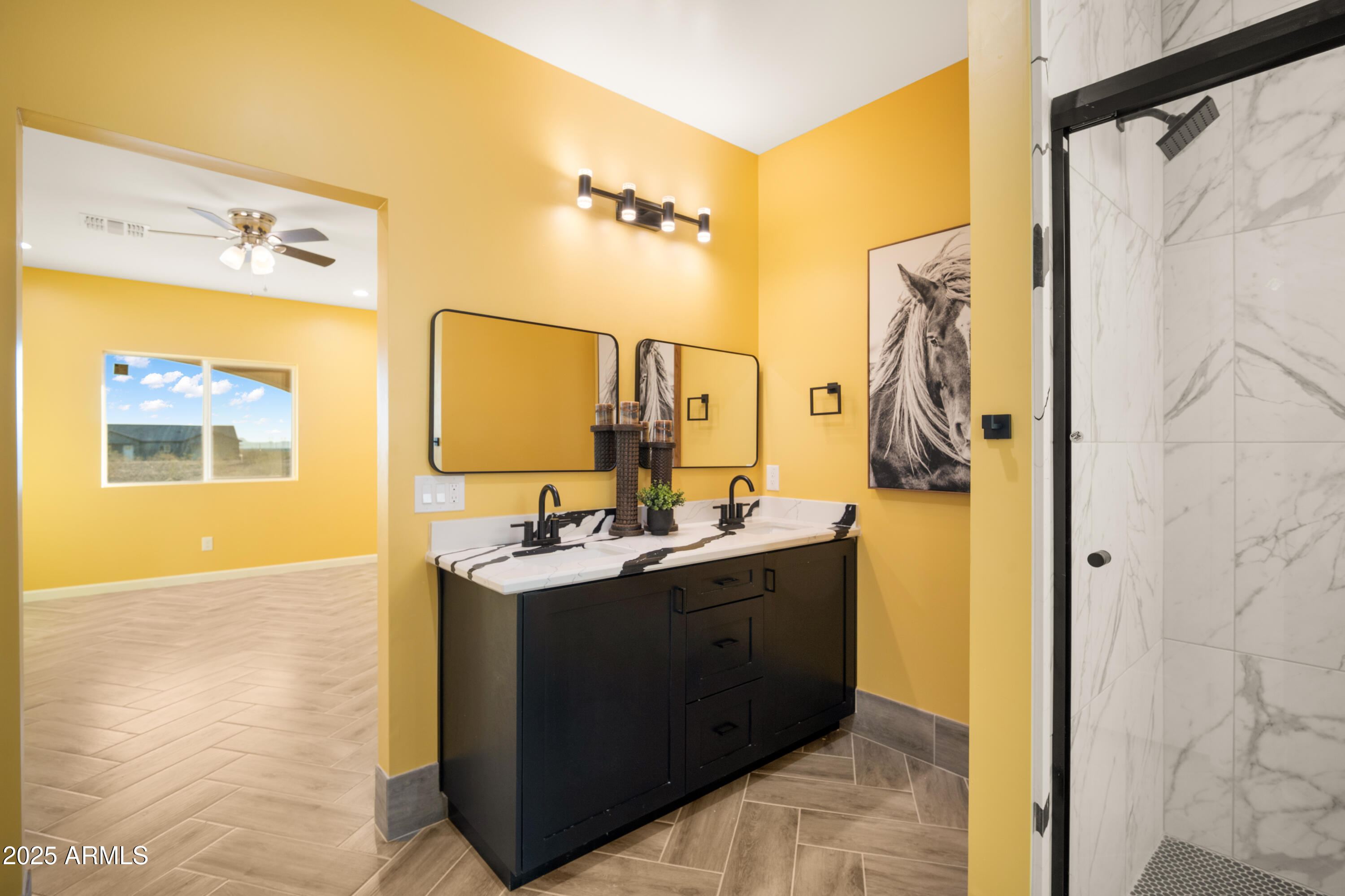 35684 West Chipman Road Tonopah, AZ 85354 - Photo 19 of 39 a bathroom with a double vanity sink a mirror and a shower