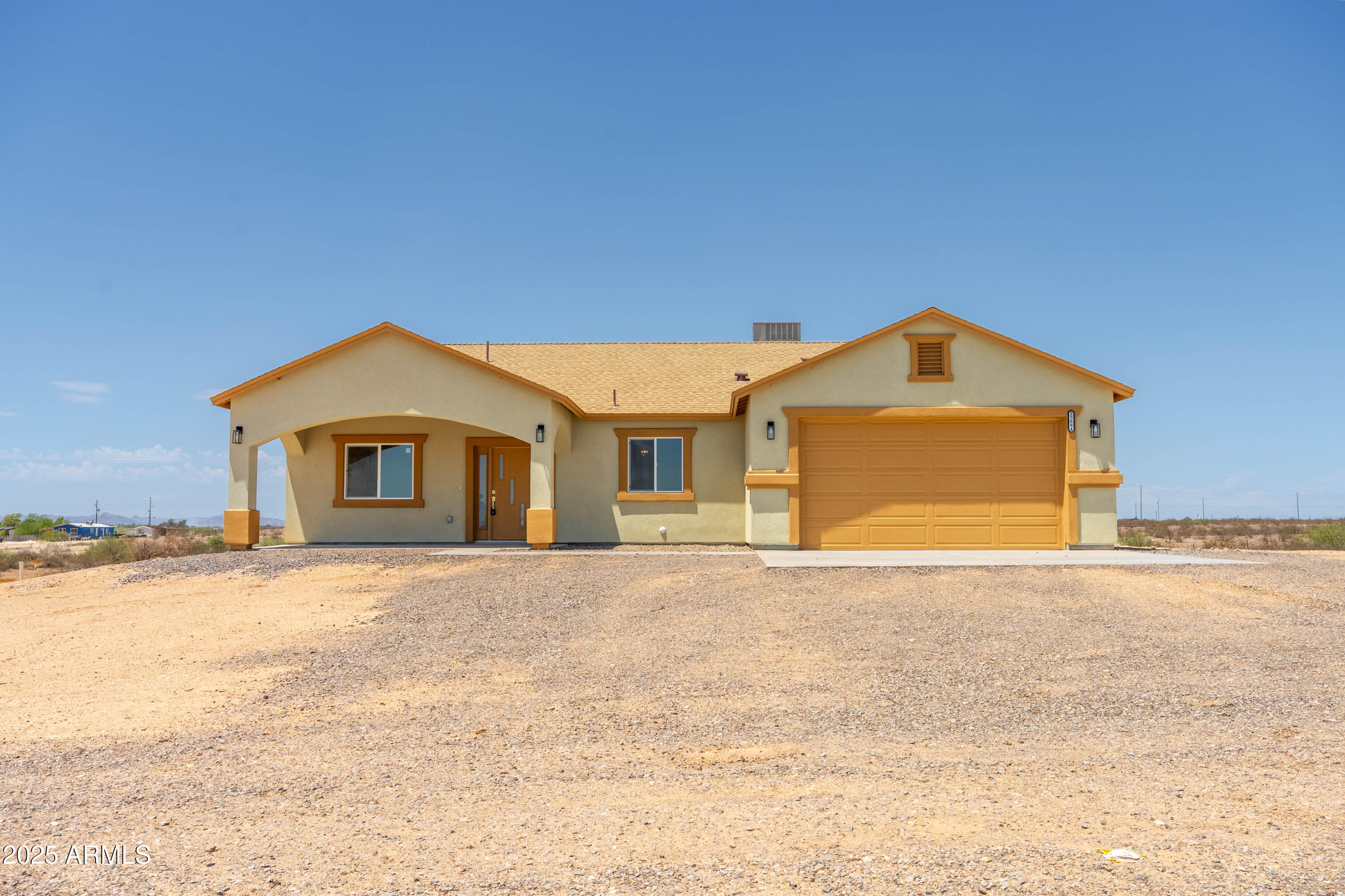 35684 West Chipman Road Tonopah, AZ 85354 - Photo 22 of 39 a front view of a house with a yard and garage