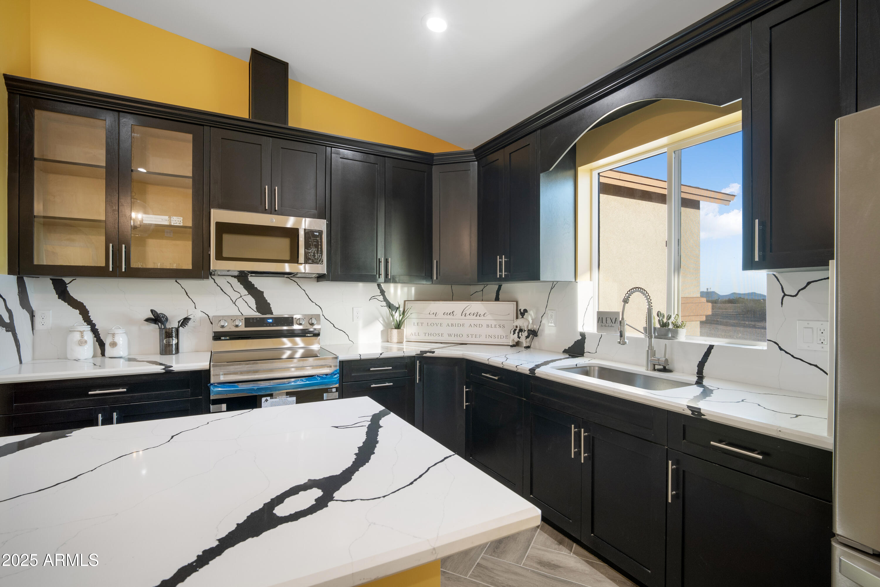 35684 West Chipman Road Tonopah, AZ 85354 - Photo 6 of 39 a kitchen with stainless steel appliances a sink stove and cabinets