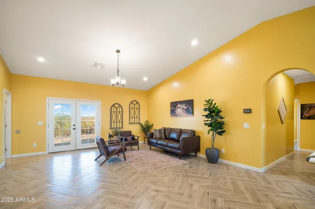 a living room with furniture and a chandelier