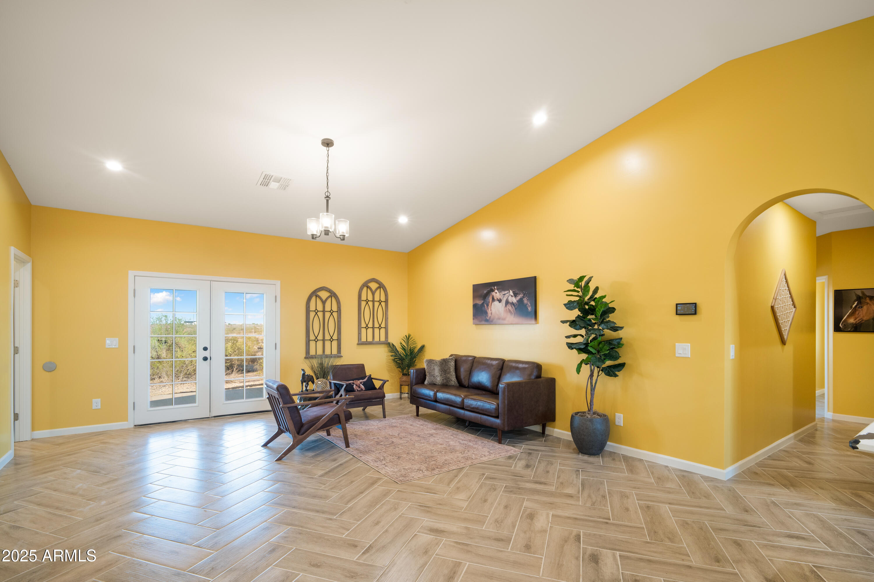 35684 West Chipman Road Tonopah, AZ 85354 - Photo 8 of 39 a living room with furniture and a chandelier