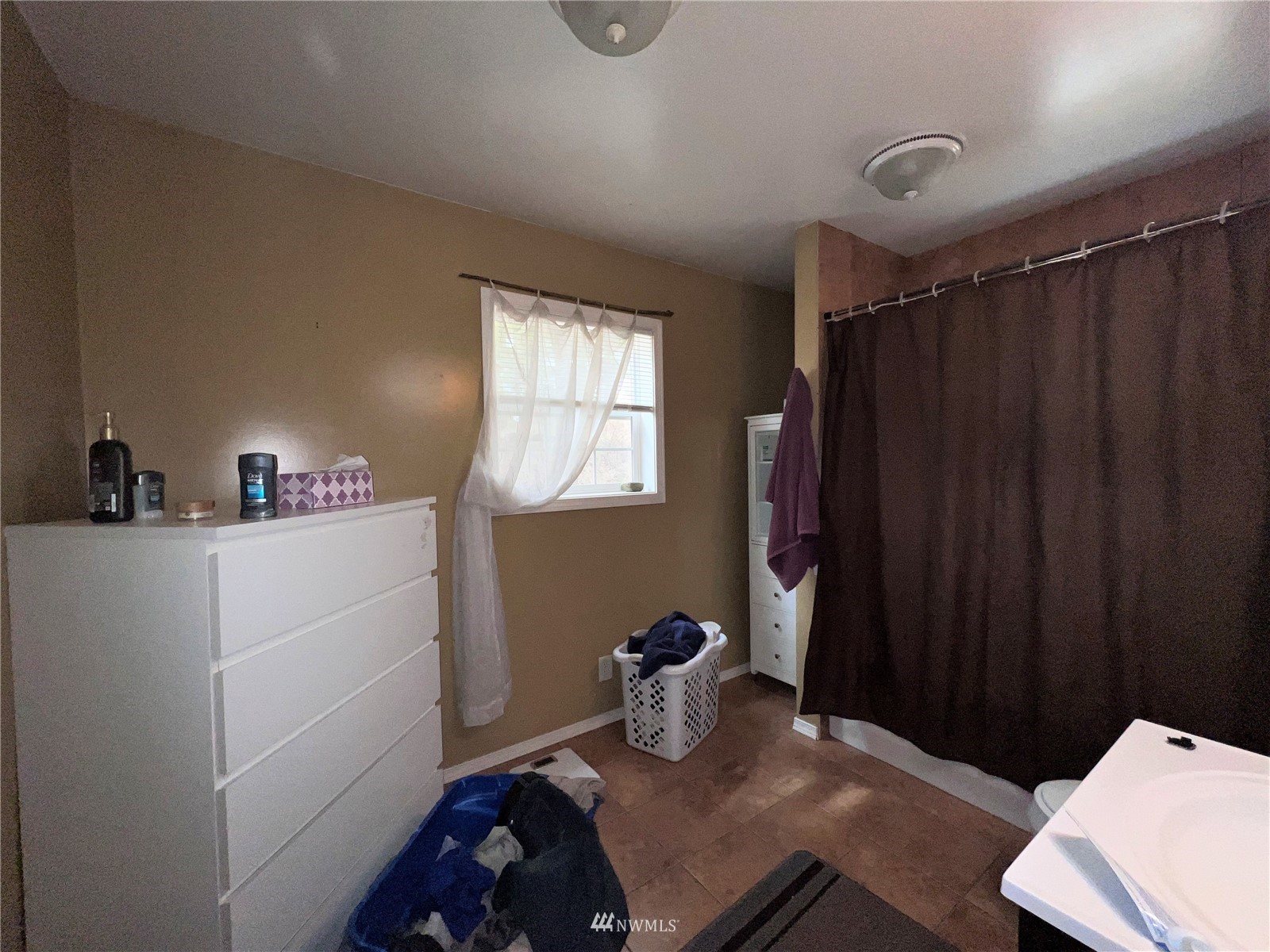 144 Roy Road Republic, WA 99166 - Photo 8 of 28 a bedroom with a bed and a closet with wooden floor