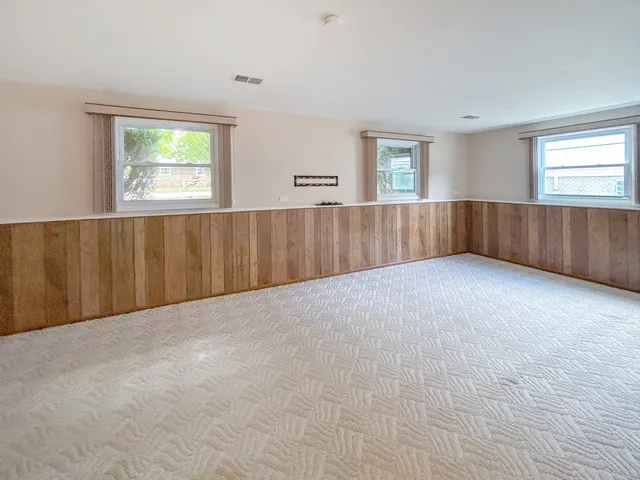 a view of an empty room with windows