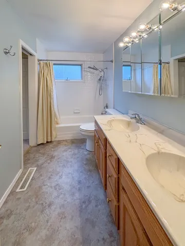 a bathroom with a granite countertop sink and a bathtub