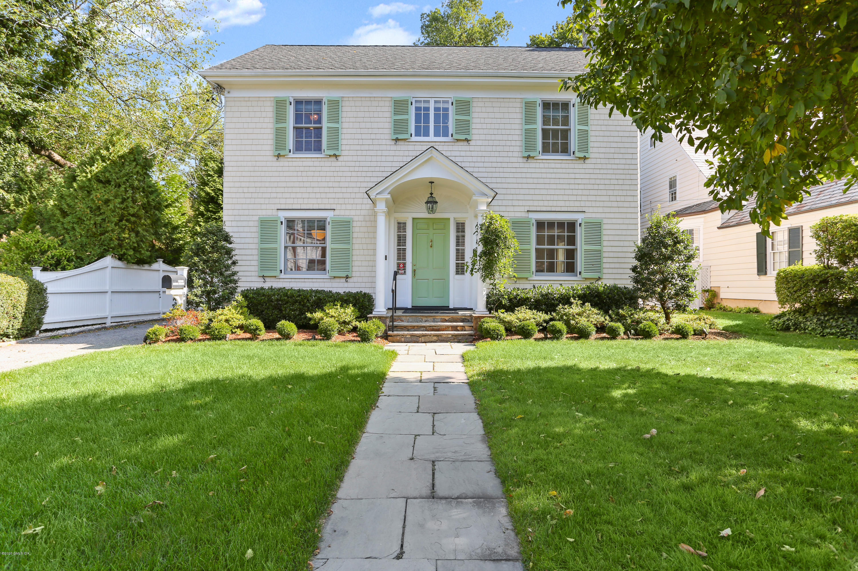 a front view of house with yard and green space