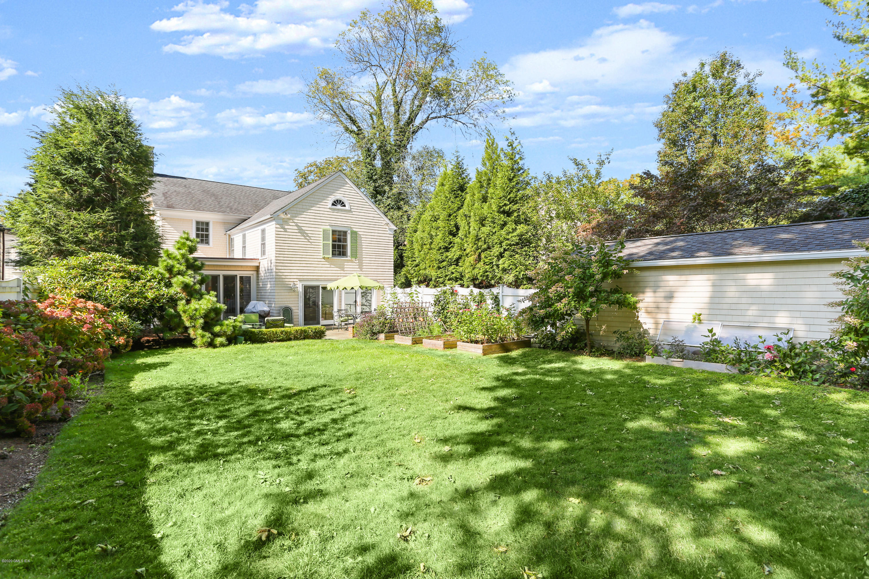 11 Maher Avenue Greenwich, CT 06830 - Photo 2 of 2 a front view of a house with a yard and trees