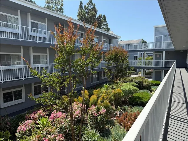 a view of a house with a yard and potted plants