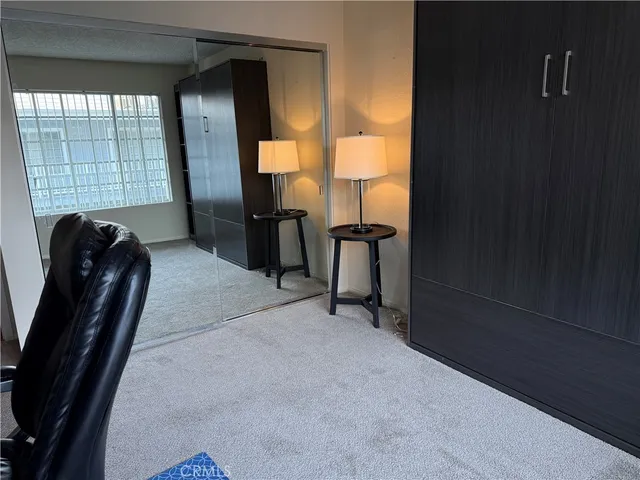 a view of a livingroom with furniture and a window