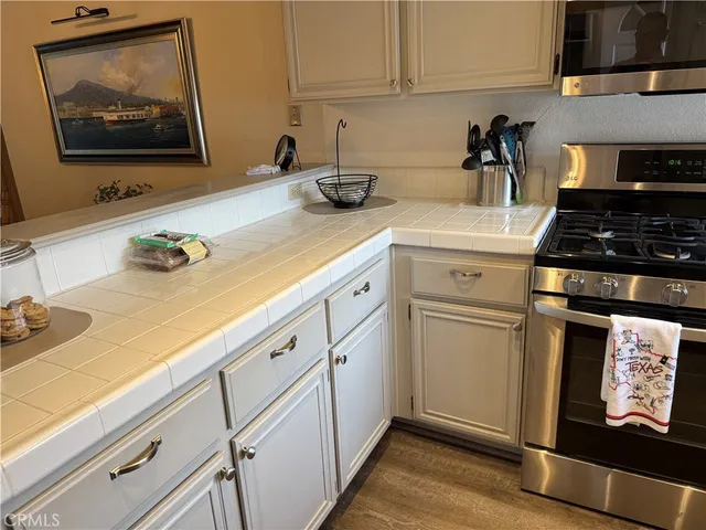 a kitchen with white cabinets and white appliances