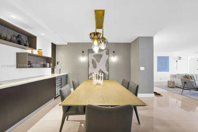 a room with kitchen island a chandelier dining table and chairs