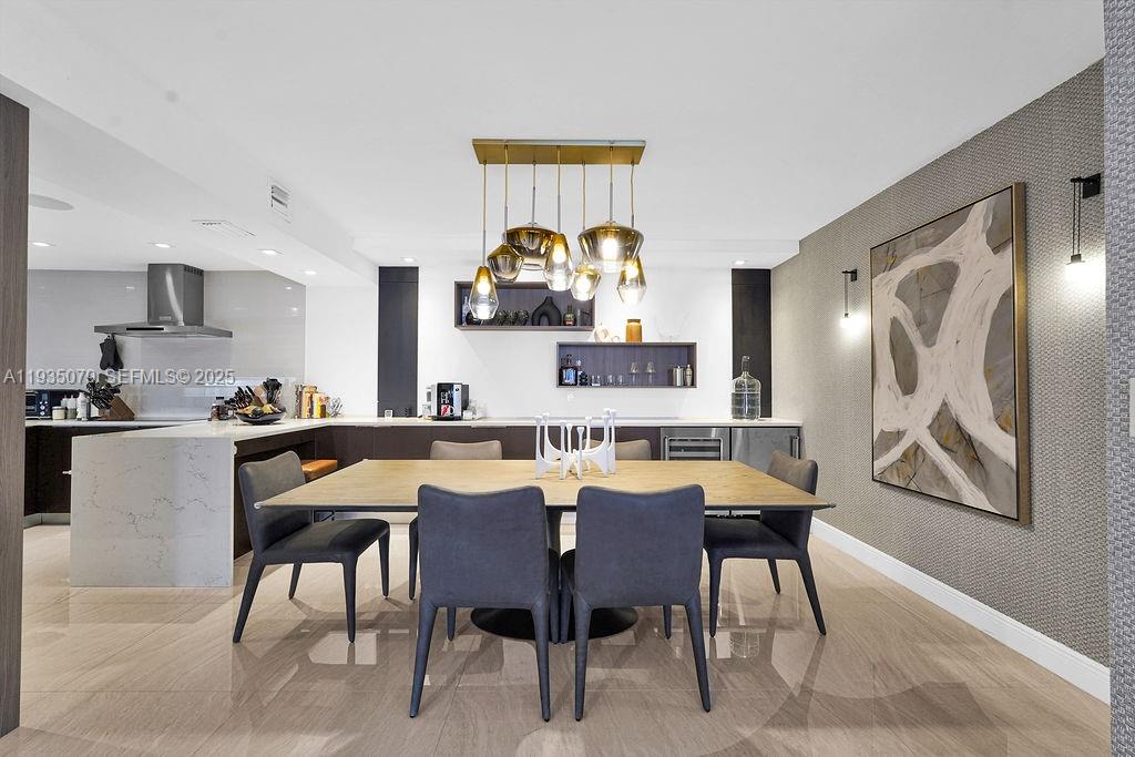 10155 Collins Avenue, Unit 1106 Bal Harbour, FL 33154 - Photo 12 of 29 a view of a dining room with furniture and chandelier