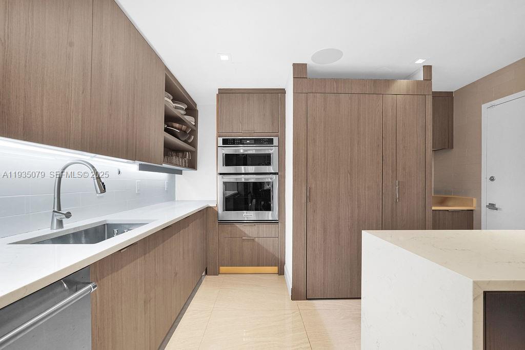 10155 Collins Avenue, Unit 1106 Bal Harbour, FL 33154 - Photo 15 of 29 a kitchen with stainless steel appliances a refrigerator and a sink