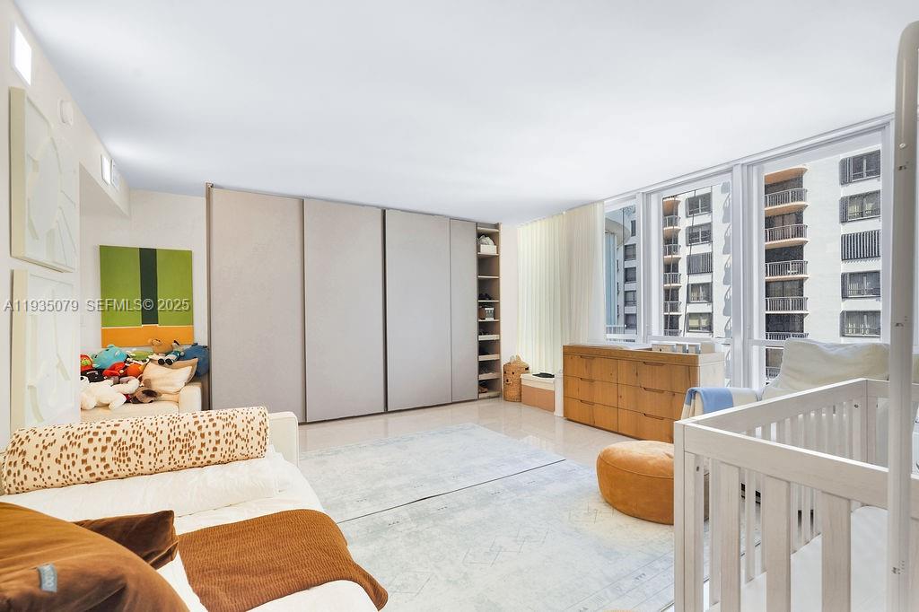 10155 Collins Avenue, Unit 1106 Bal Harbour, FL 33154 - Photo 19 of 29 a bedroom with furniture and windows