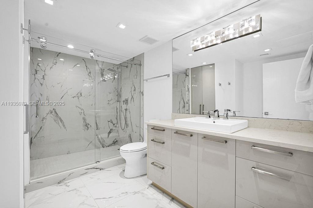 10155 Collins Avenue, Unit 1106 Bal Harbour, FL 33154 - Photo 20 of 29 a bathroom with a sink toilet and shower