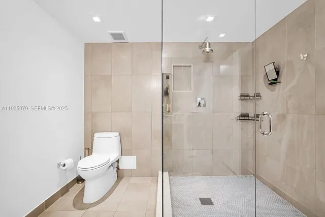 a bathroom with a shower and toilet