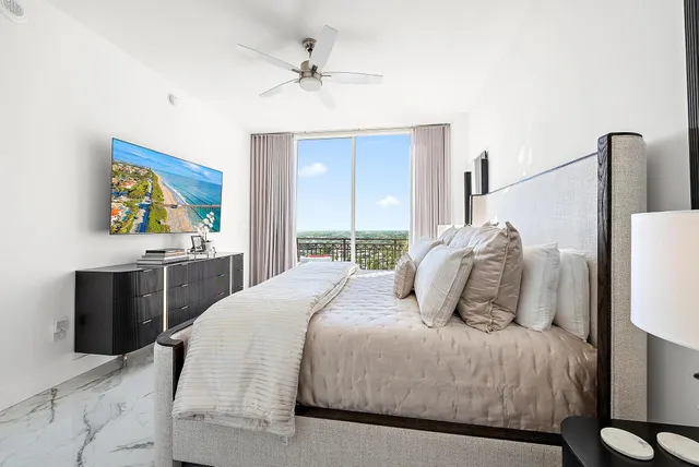 a bedroom with a bed and a painting on the wall