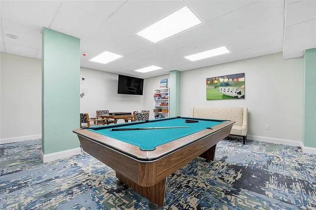 a room with pool table and flat screen tv