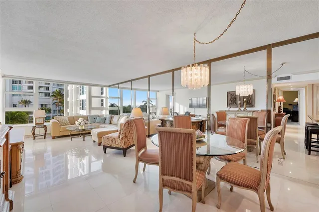 a view of dining room and livingroom with furniture wooden floor and a large window