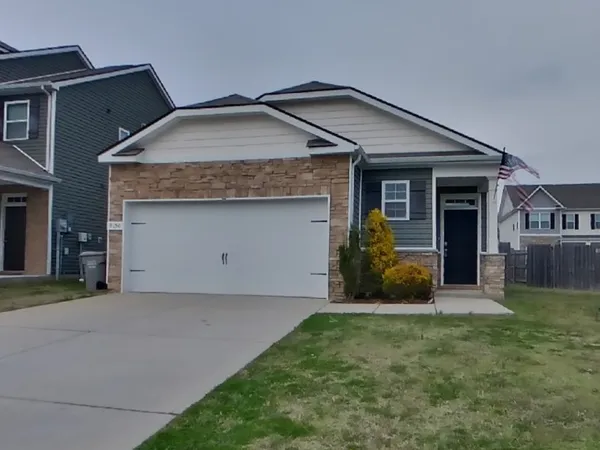 a front view of a house with a yard and garage