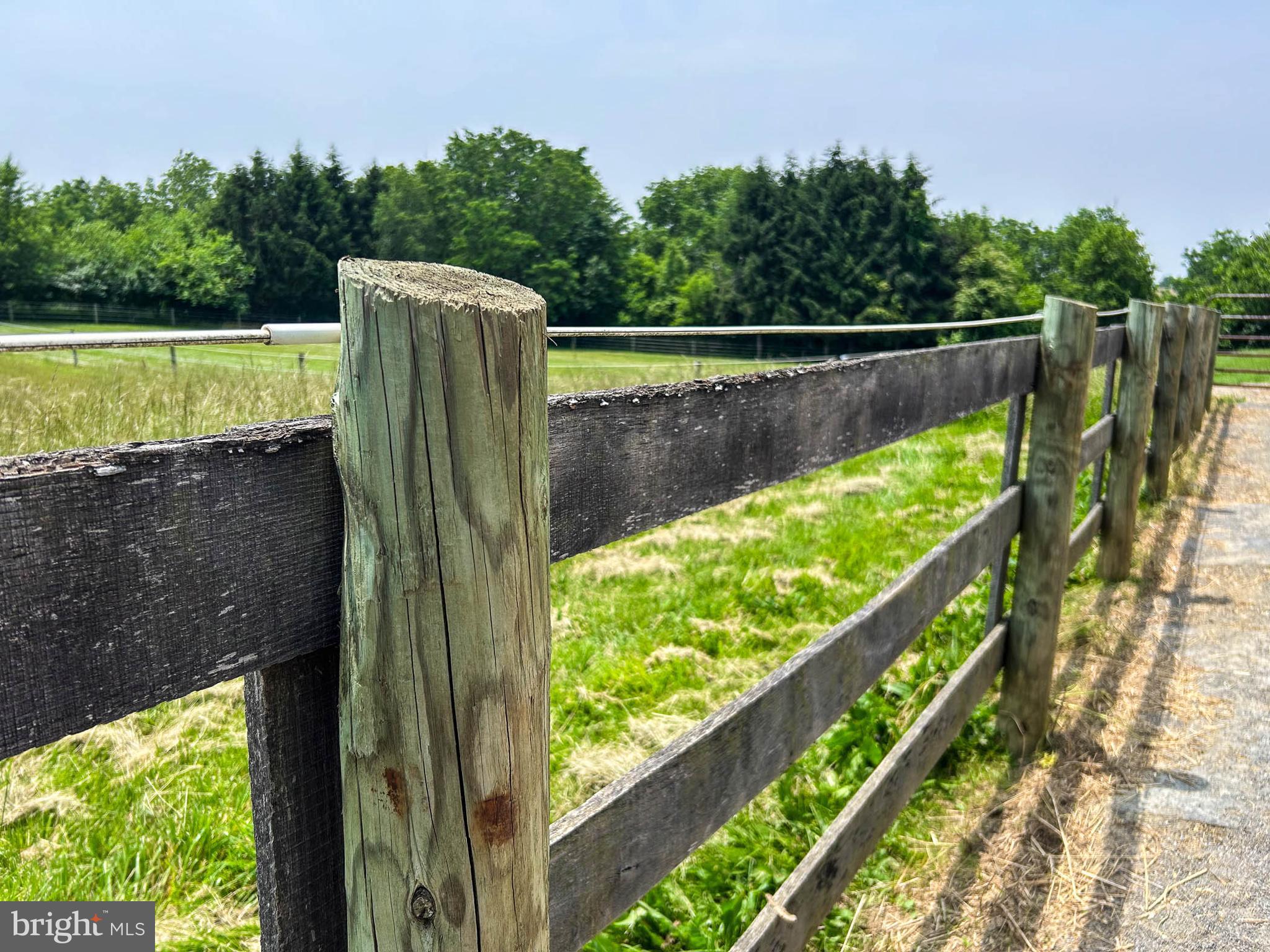 1392 Wakefield Valley Road New Windsor, MD 21776 - Photo 35 of 144 three-board fence borders the lane and dry lots