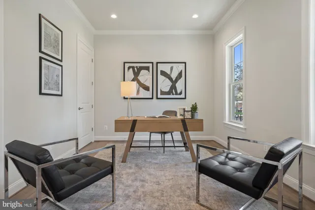 a living room with furniture a large window and a fireplace
