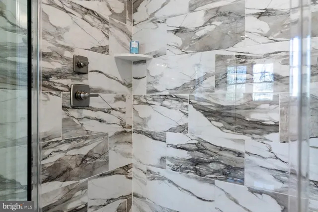 a kitchen with a sink dishwasher a stove and white cabinets with wooden floor