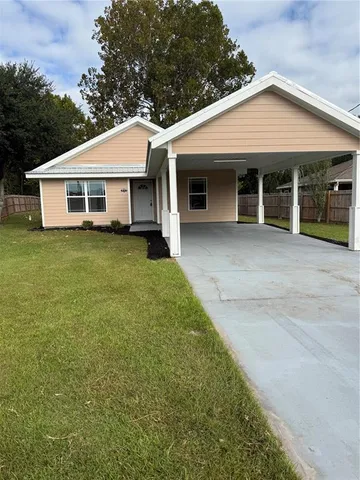 a front view of a house with a garden