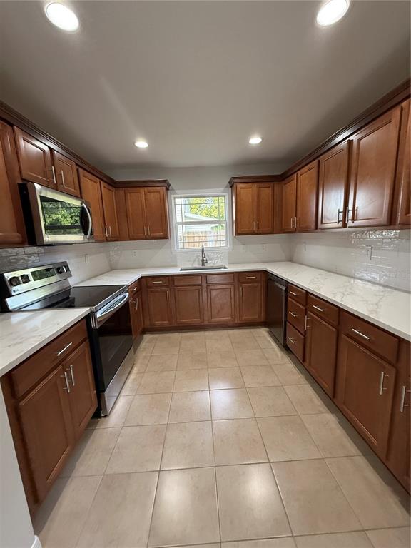 237 Northeast Gum Swamp Road Lake City, FL 32055 - Photo 11 of 34 a large kitchen with stainless steel appliances granite countertop a stove sink and cabinets
