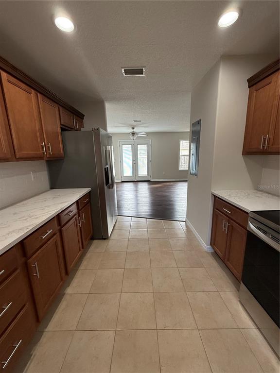 237 Northeast Gum Swamp Road Lake City, FL 32055 - Photo 13 of 34 a kitchen with granite countertop a stove a sink and a refrigerator