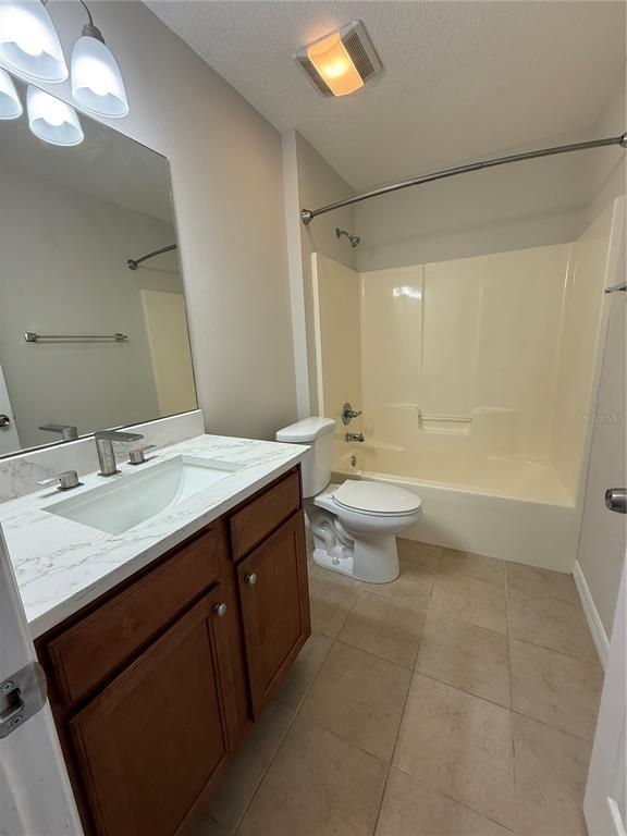 237 Northeast Gum Swamp Road Lake City, FL 32055 - Photo 17 of 34 a bathroom with a granite countertop sink a toilet a mirror and shower