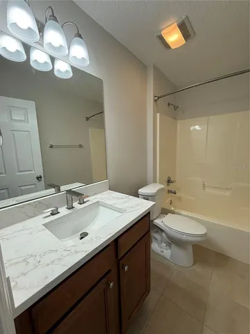 a bathroom with a double vanity sink toilet and shower