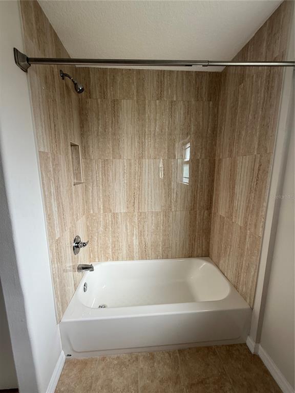 237 Northeast Gum Swamp Road Lake City, FL 32055 - Photo 26 of 34 a bathroom with a bathtub and a shower