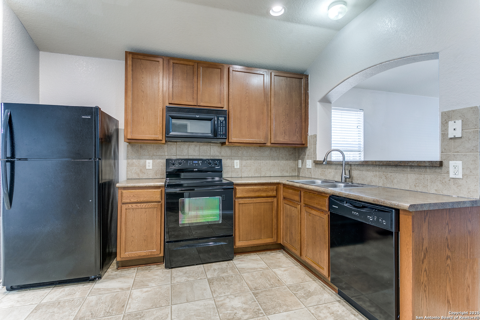 3603 Aranda Fields Converse, TX 78109 - Photo 3 of 13 a kitchen with stainless steel appliances granite countertop a refrigerator stove a sink and dishwasher