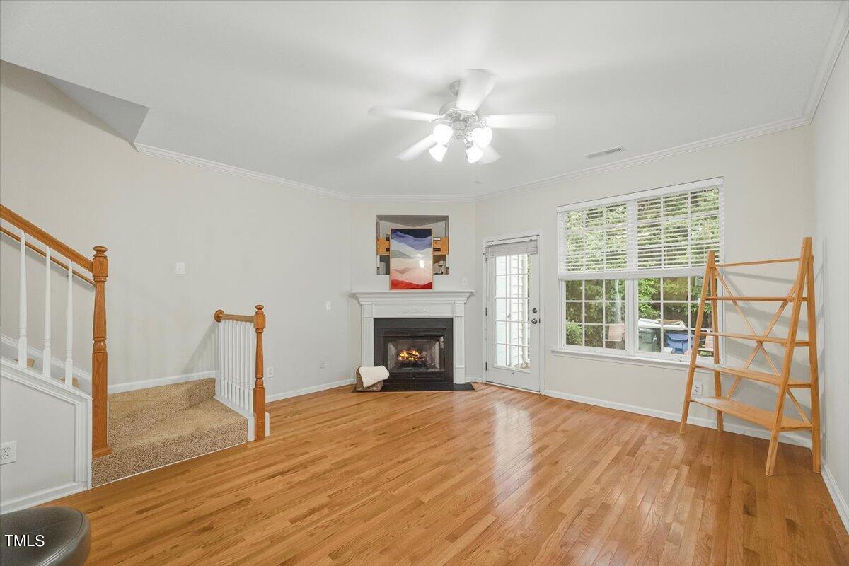 4508 Sugarbend Way Raleigh, NC 27606 - Photo 15 of 39 a view of an empty room with wooden floor fireplace and a window