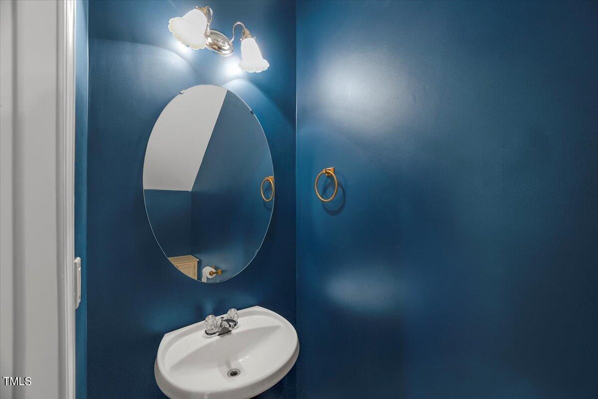 4508 Sugarbend Way Raleigh, NC 27606 - Photo 18 of 39 a bathroom with a sink and mirror