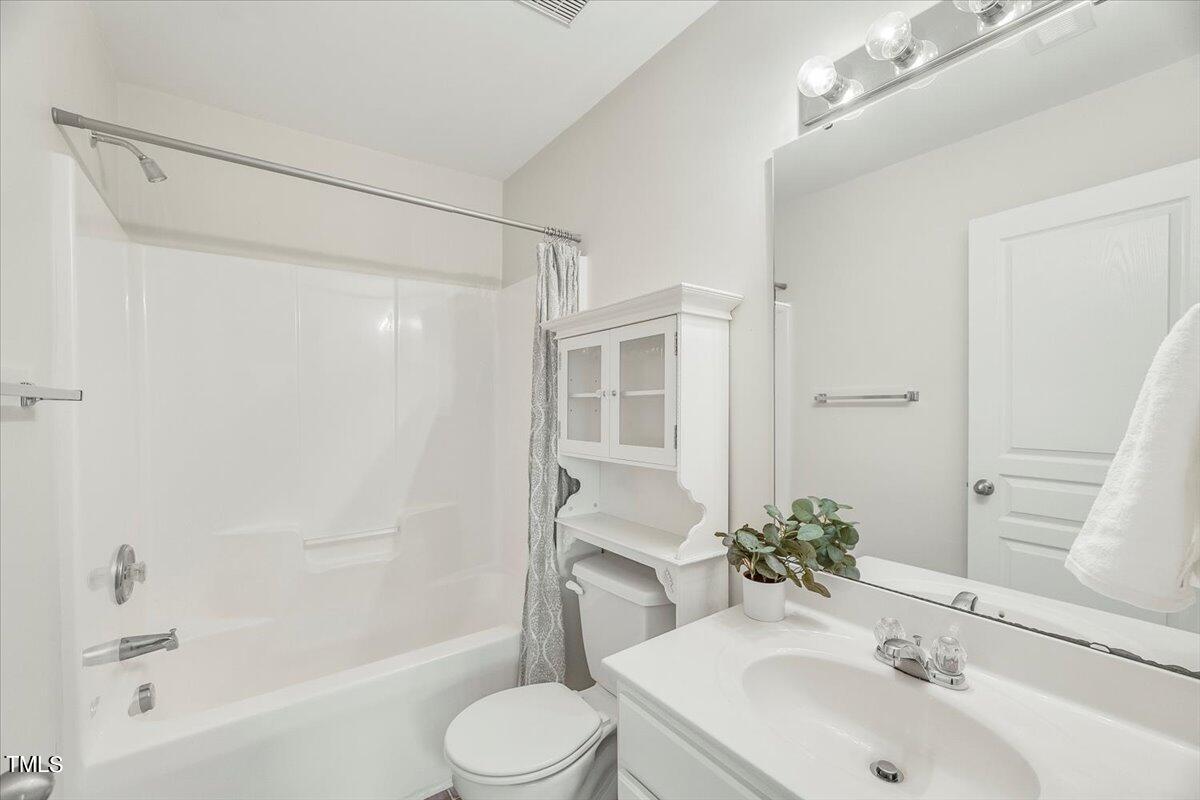 4508 Sugarbend Way Raleigh, NC 27606 - Photo 21 of 39 a bathroom with a sink toilet and shower
