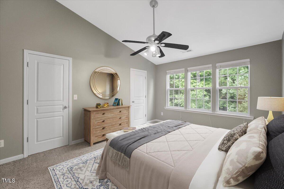 4508 Sugarbend Way Raleigh, NC 27606 - Photo 23 of 39 a bedroom with a bed and a chandelier