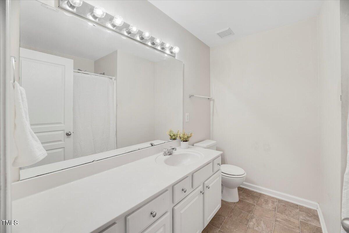 4508 Sugarbend Way Raleigh, NC 27606 - Photo 27 of 39 a spacious bathroom with a toilet sink and mirror