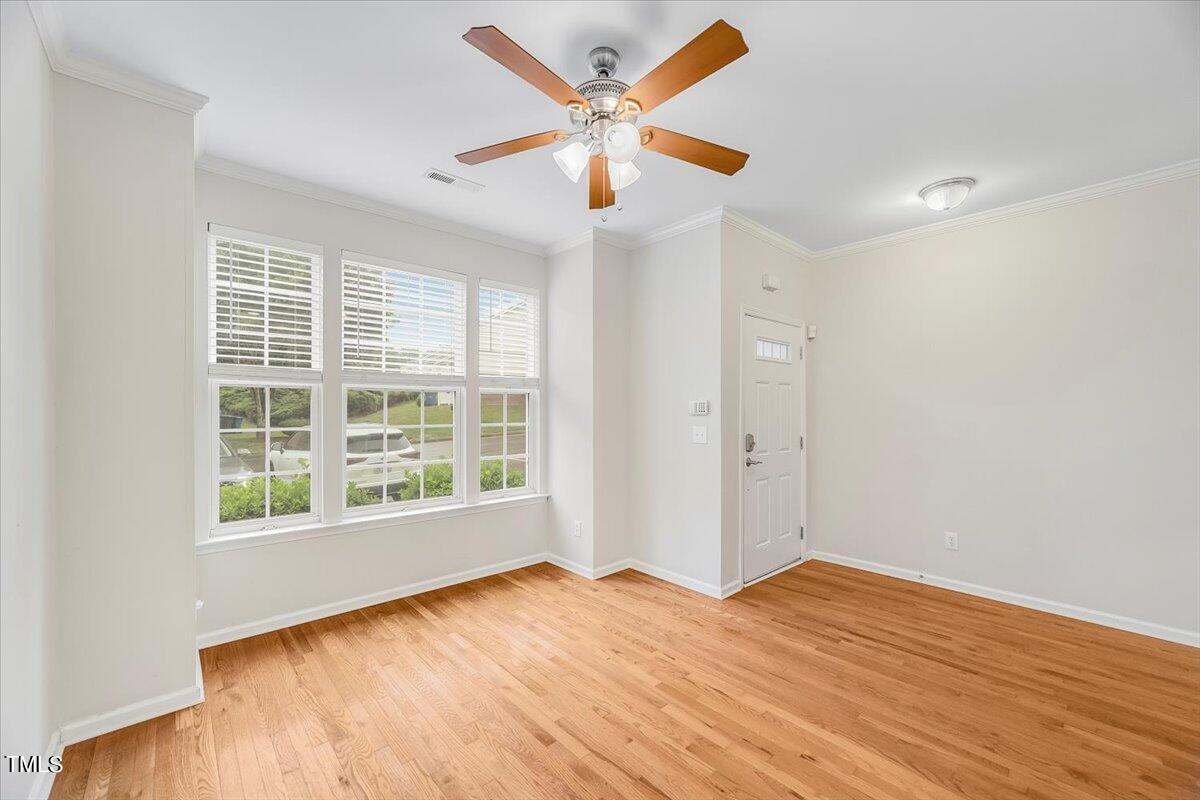 4508 Sugarbend Way Raleigh, NC 27606 - Photo 5 of 39 an empty room with wooden floor and windows