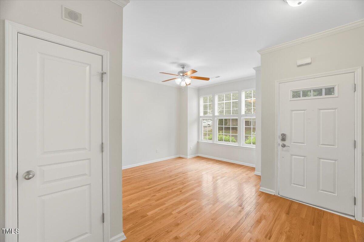 4508 Sugarbend Way Raleigh, NC 27606 - Photo 8 of 39 a view of an empty room with a window and wooden floor