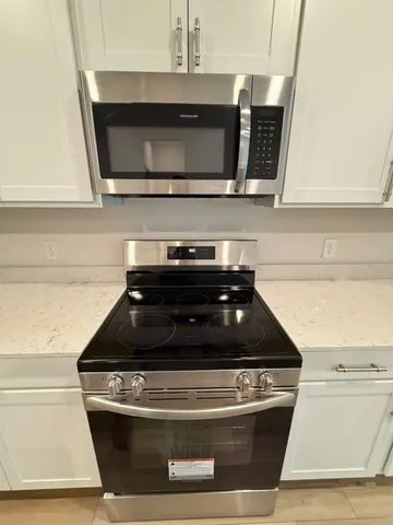a kitchen with a stove and a microwave