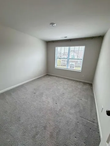 an empty room with a empty space and windows