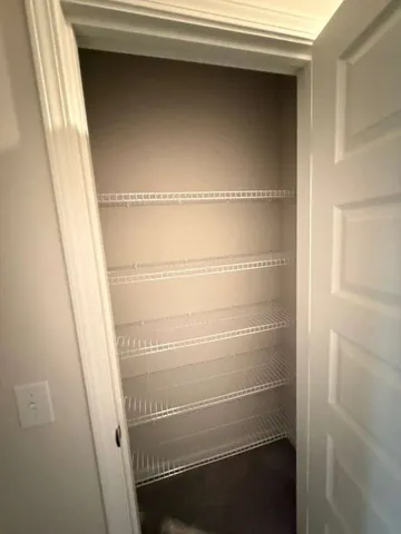 a view of a hallway with a wooden door