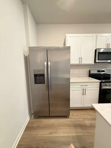 a kitchen with a refrigerator and a stove