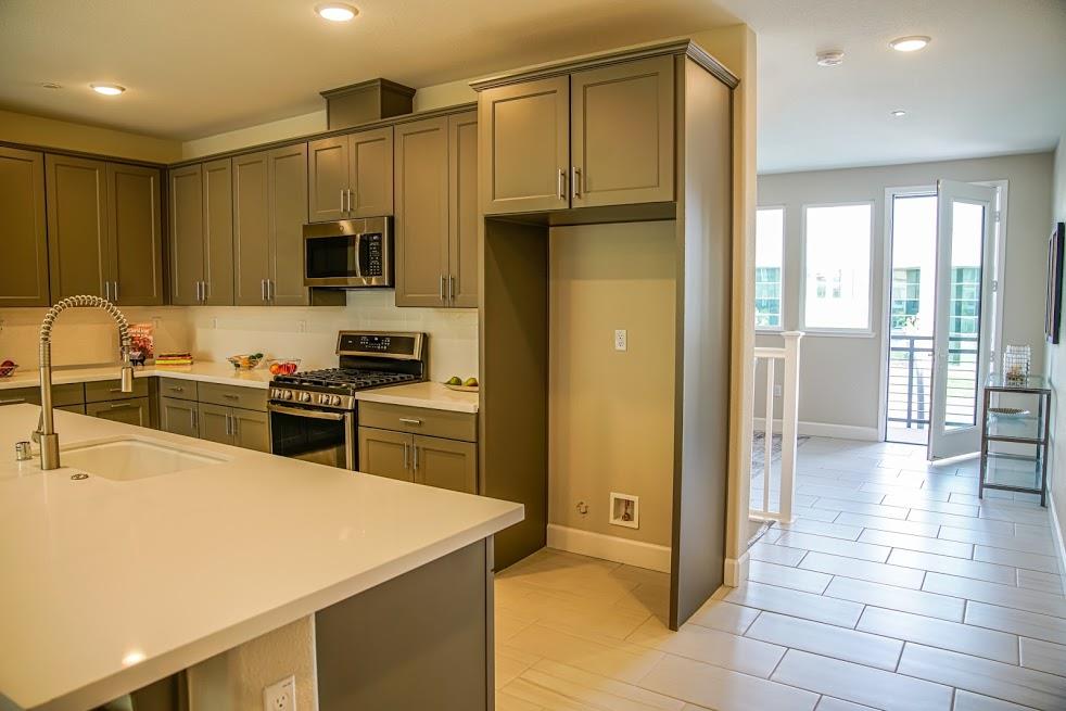 81 South Milpitas Boulevard Milpitas, CA 95035 - Photo 15 of 40 a kitchen with a refrigerator a sink and a stove top oven