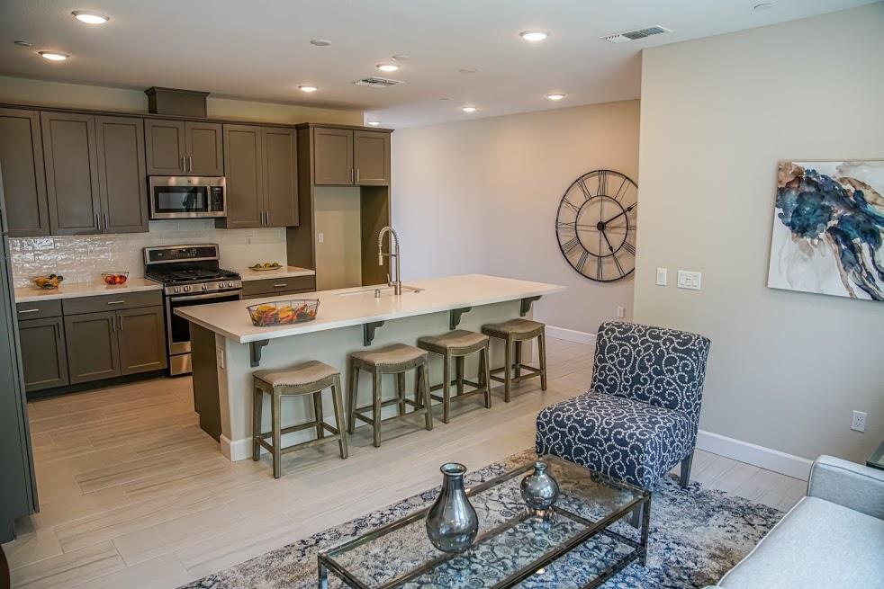 81 South Milpitas Boulevard Milpitas, CA 95035 - Photo 21 of 40 a kitchen with stainless steel appliances granite countertop a table chairs sink and cabinets