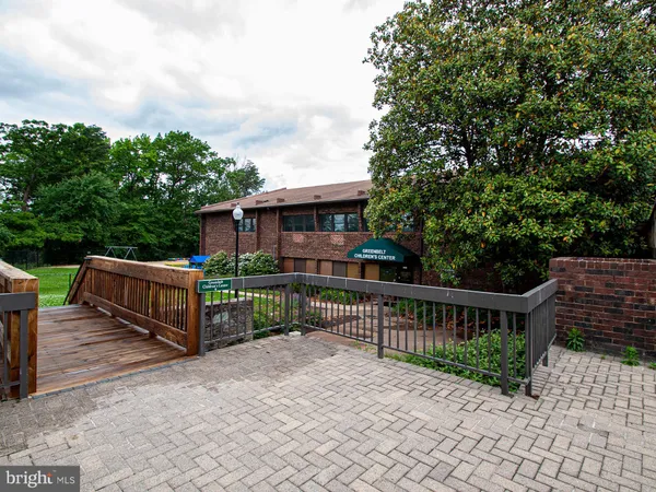 a view of a house with wooden deck and a backyard