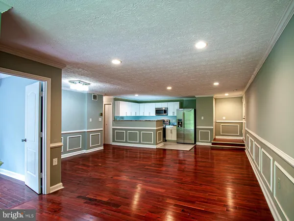 a view of a room with wooden floor