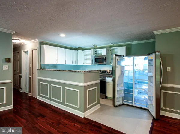 a kitchen with stainless steel appliances a stove a refrigerator and a sink