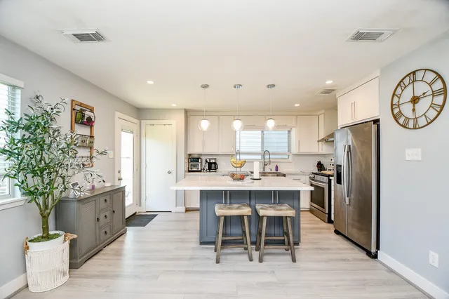 a large kitchen with a table and chairs